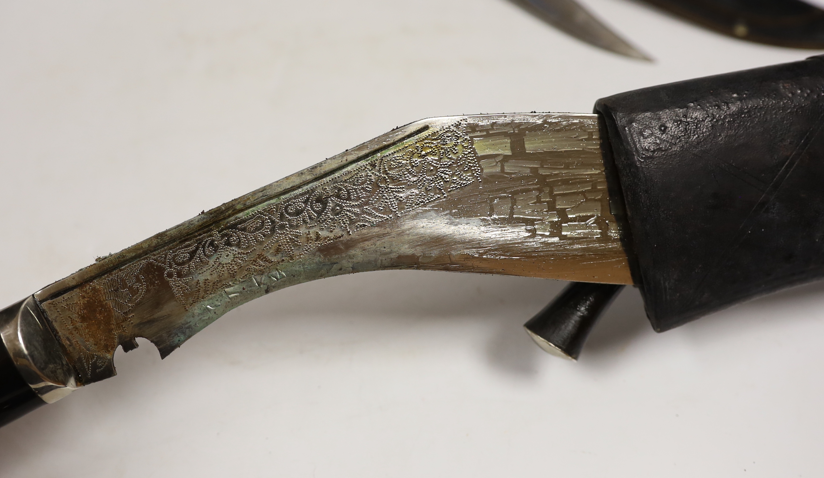 Two large kukris and a smaller similar kukri